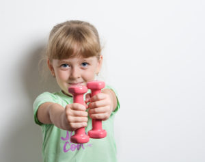 child lifting small weights