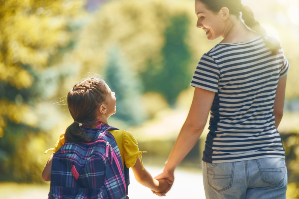 mother hand in hand with school age girl